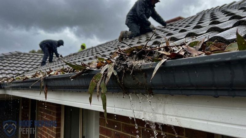 Heavily blocked gutter overflowing with leaves and debris during Perth winter rainfall