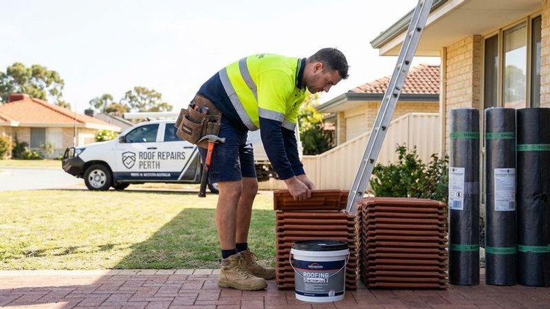 Roofer preparing materials and tools for a roof leak repair job on a Perth residential home